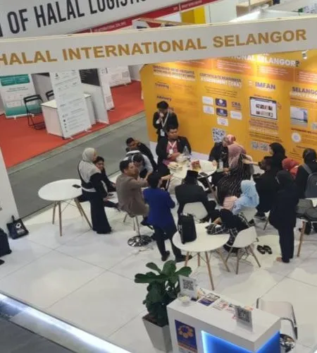 Visitors meeting at a halal industry exhibition booth in Selangor